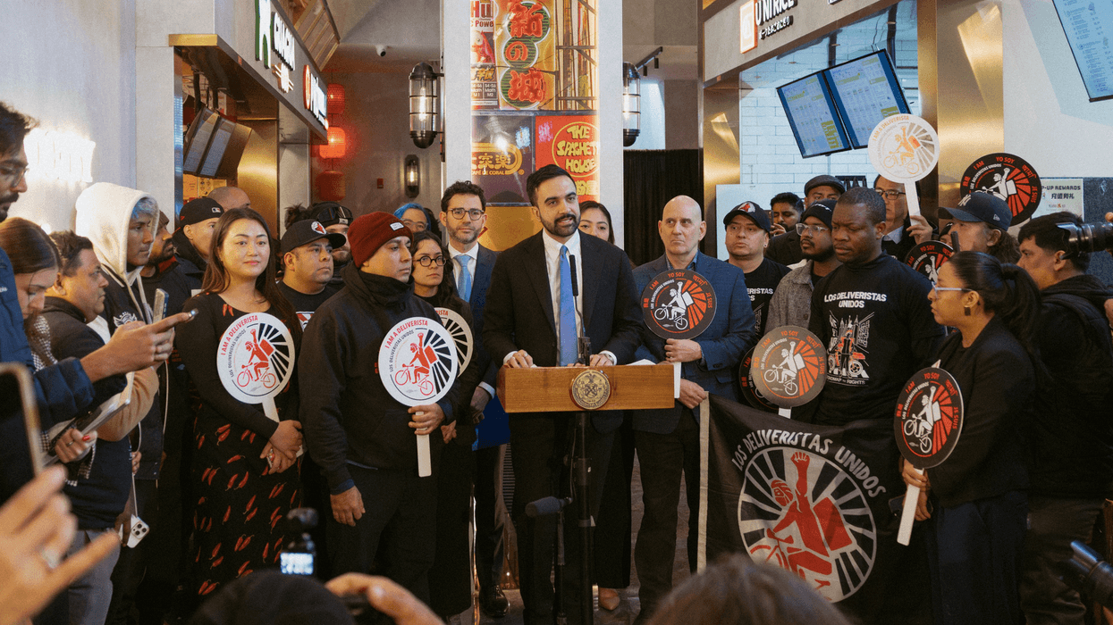 New York City Mayor Zohran Mamdani stands with delivery workers
