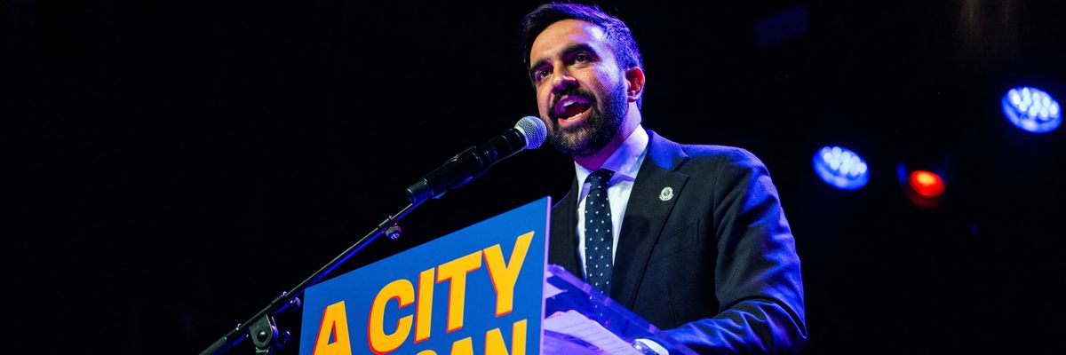 New York City mayoral candidate Zohran Mamdani speaks enthusiastically into a mic.