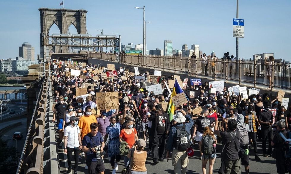 New York City Public Advocate Jumaane D. Williams leads a crowd of thousands in a silent protest walk across the Brooklyn Bridge on June 9, 2020, the day that George Floyd was buried. (Photo: Ira L. Black/Corbis/Getty Images)