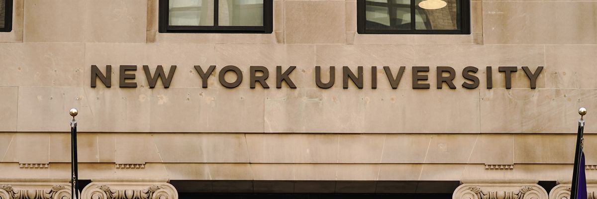 New York University in brown letters on a beige campus building.