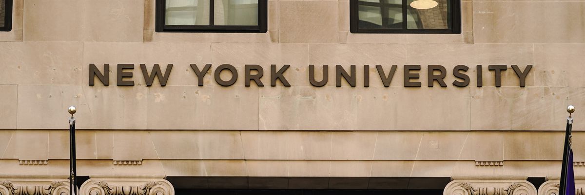 New York University in brown letters on a beige campus building. 