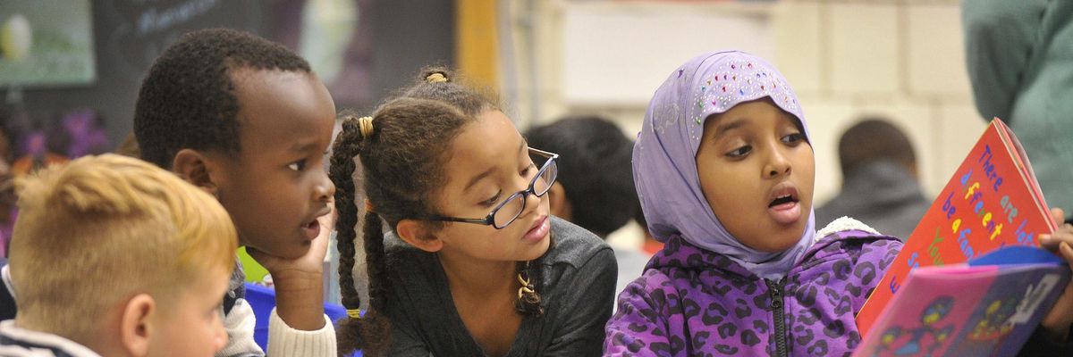 Nine-year-old Nasra Omar reads a book to 1st graders at Riverton Elementary School. The school's mentoring Civil Rights Team, made up of 4th and 5th graders, read books to kindergartners and first graders about civil rights and anti-bias themes in Portland, Maine. (Photo: John Ewing/Portland Portland Press Herald via Getty Images)