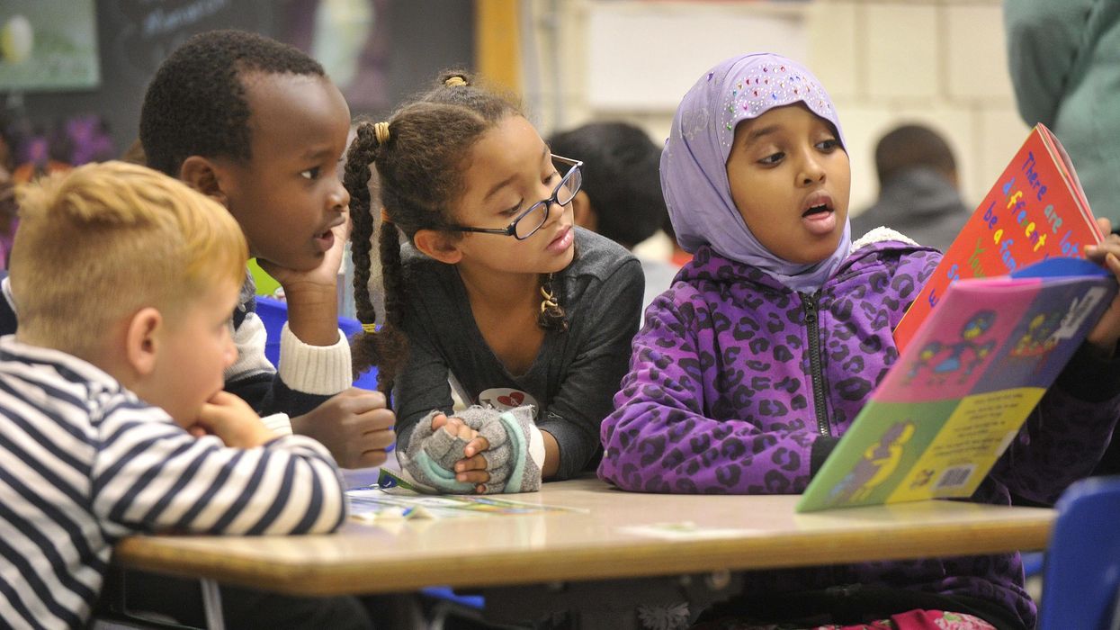 Nine-year-old Nasra Omar reads a book to 1st graders at Riverton Elementary School. The school's mentoring Civil Rights Team, made up of 4th and 5th graders, read books to kindergartners and first graders about civil rights and anti-bias themes in Portland, Maine. (Photo: John Ewing/Portland Portland Press Herald via Getty Images)