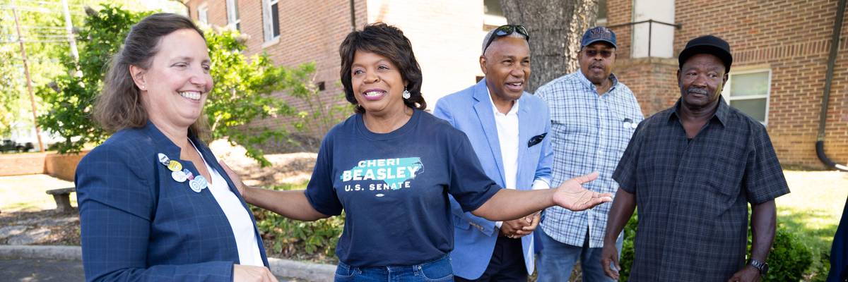 North Carolina Democratic Senate candidate Cheri Beasley (second from left) speaks with voters outside a polling location on May 17, 2022 in Troy, North Carolina.