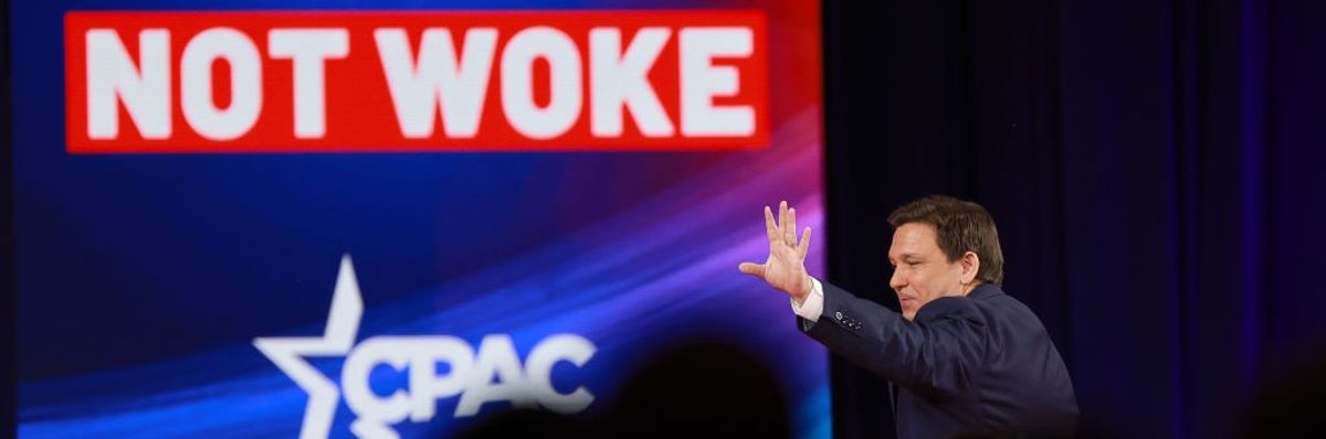 "Not Woke" sign and Ron DeSantis