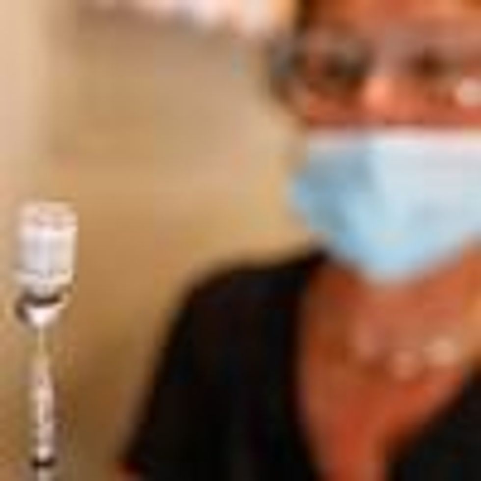 Nurse holds vial of Pfizer vaccine