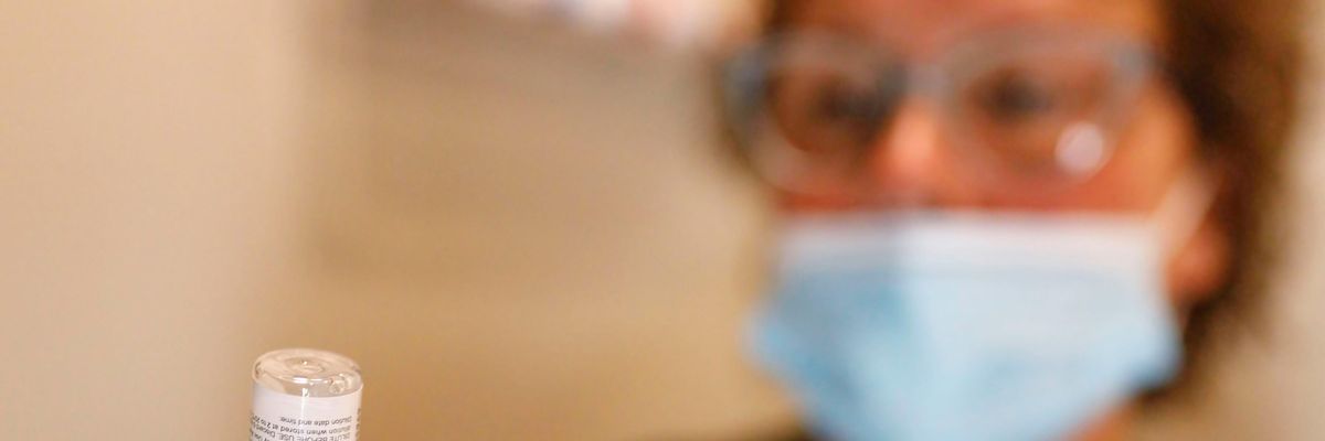 Nurse holds vial of Pfizer vaccine