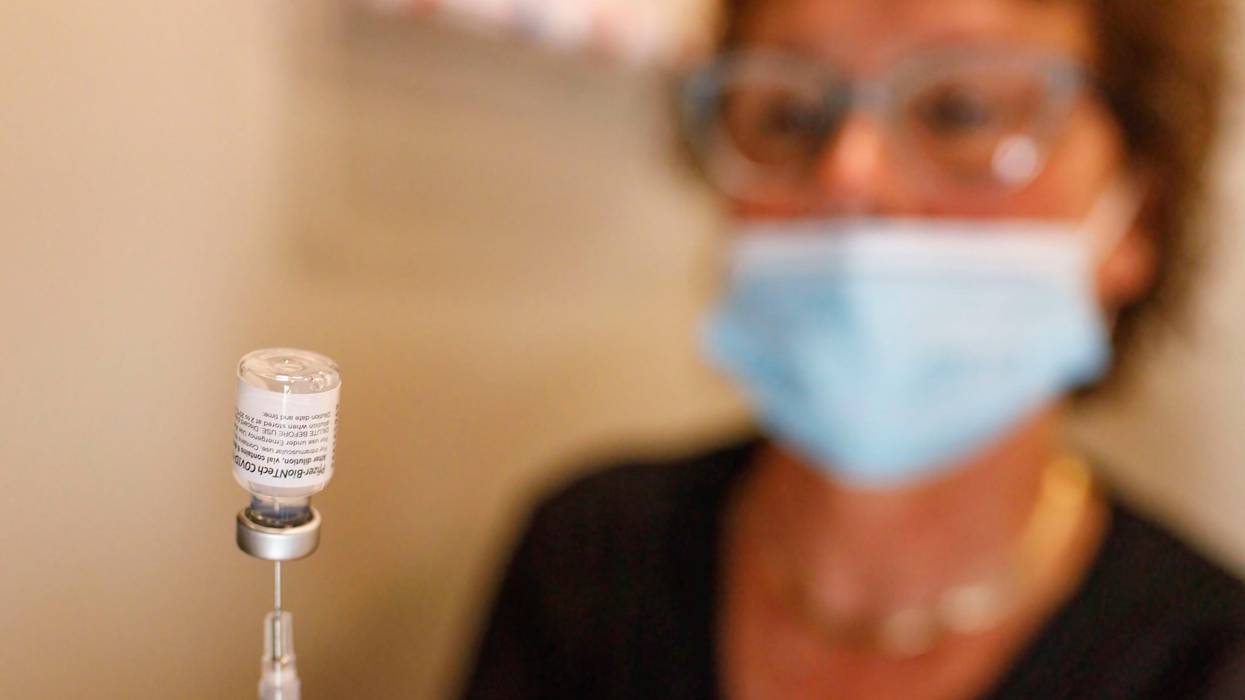 Nurse holds vial of Pfizer vaccine