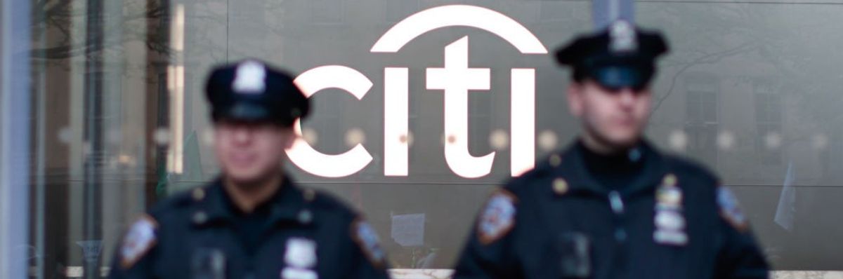 NYPD officers stand guard as Extinction Rebellion demonstrators gather outside Citibank Plaza in New York City