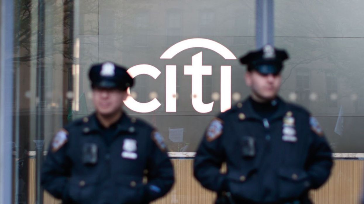 NYPD officers stand guard as Extinction Rebellion demonstrators gather outside Citibank Plaza in New York City