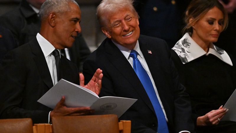 Obama whispers to a laughing Trump.