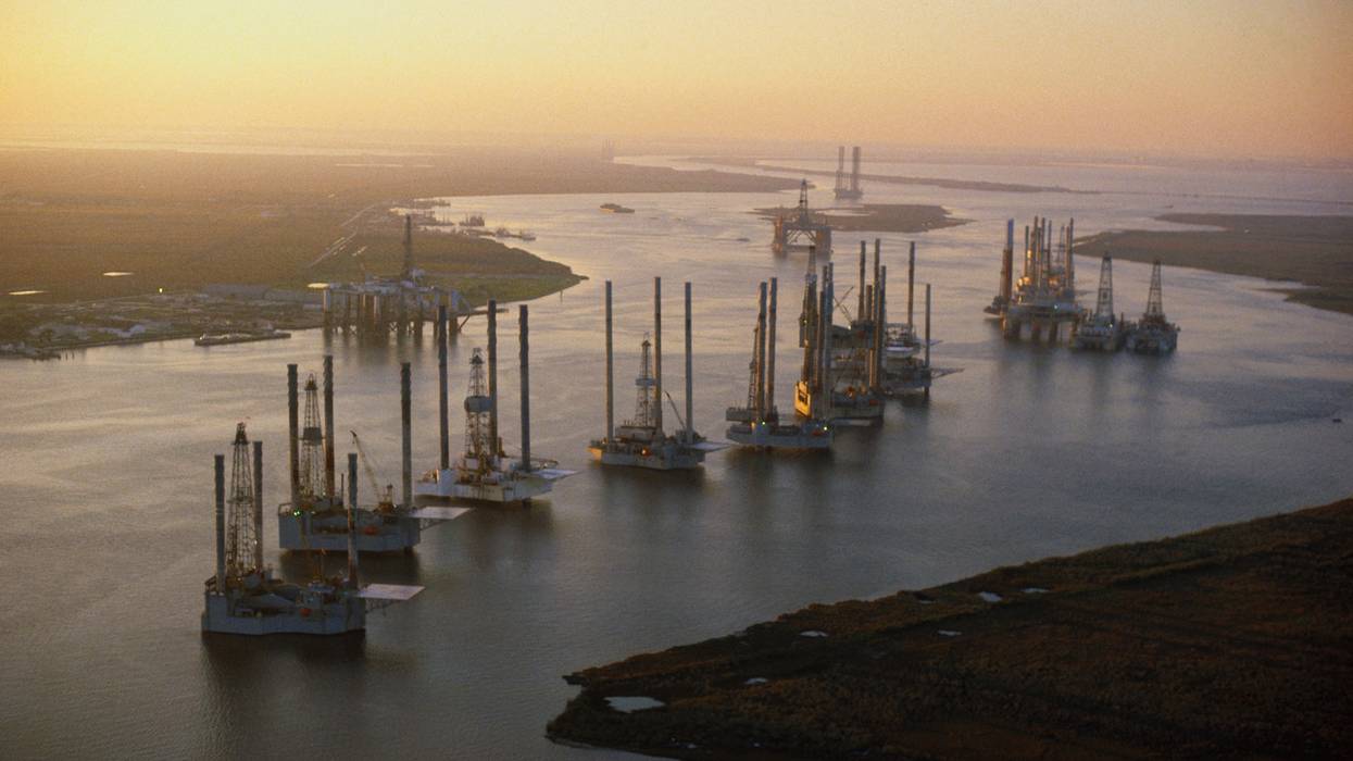 Offshore oil drilling platforms in the sunset.