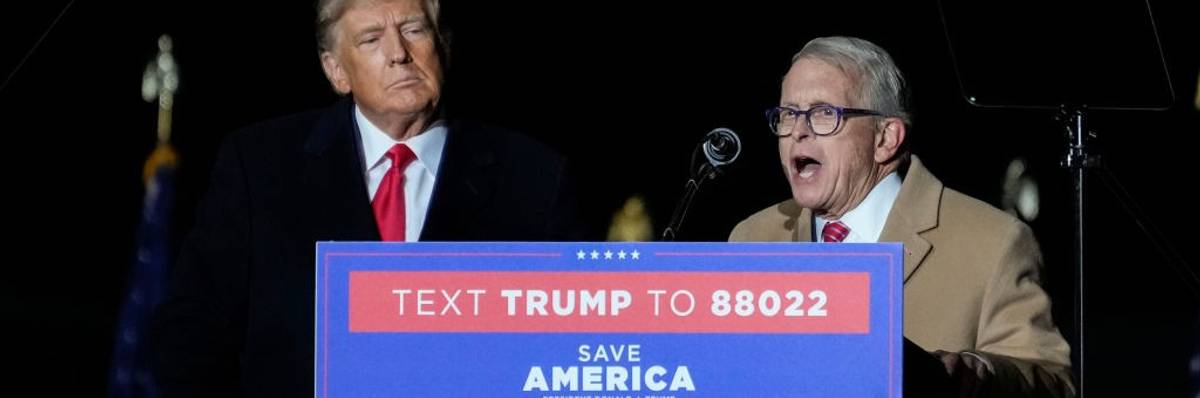Ohio Gov. Mike DeWine speaks as former President Donald Trump looks on