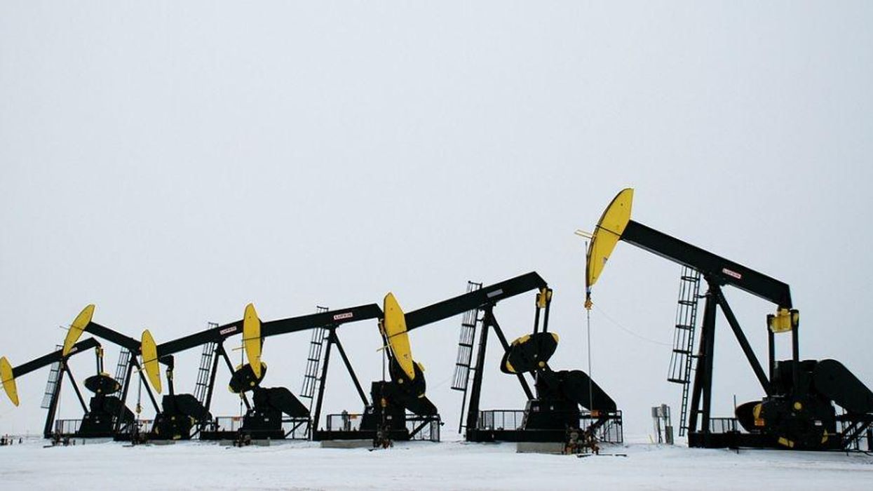 Oil pumps lined up in the snow.