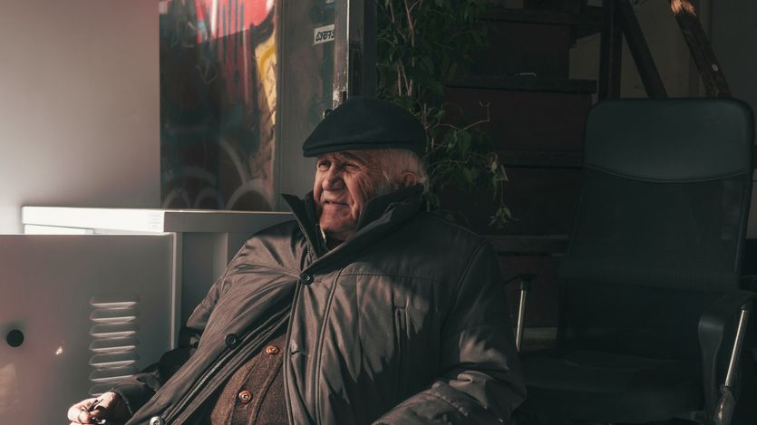 Old man leaning in chair.