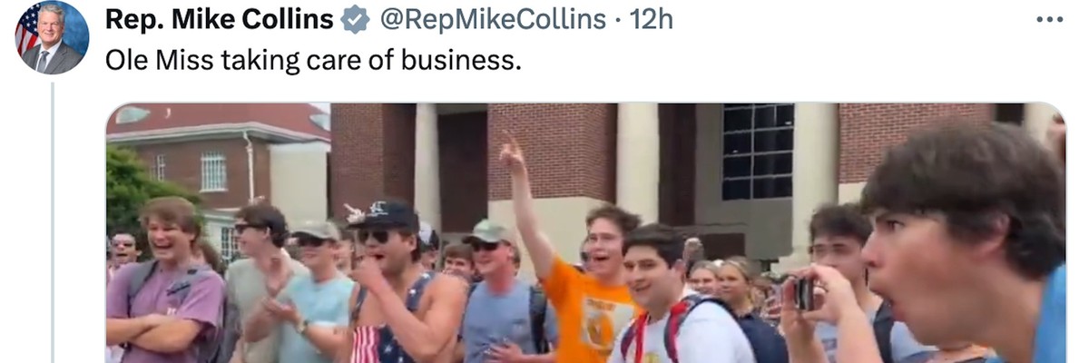 Ole Miss students make ape noises while a white male student jump ups and down in front of a Black student