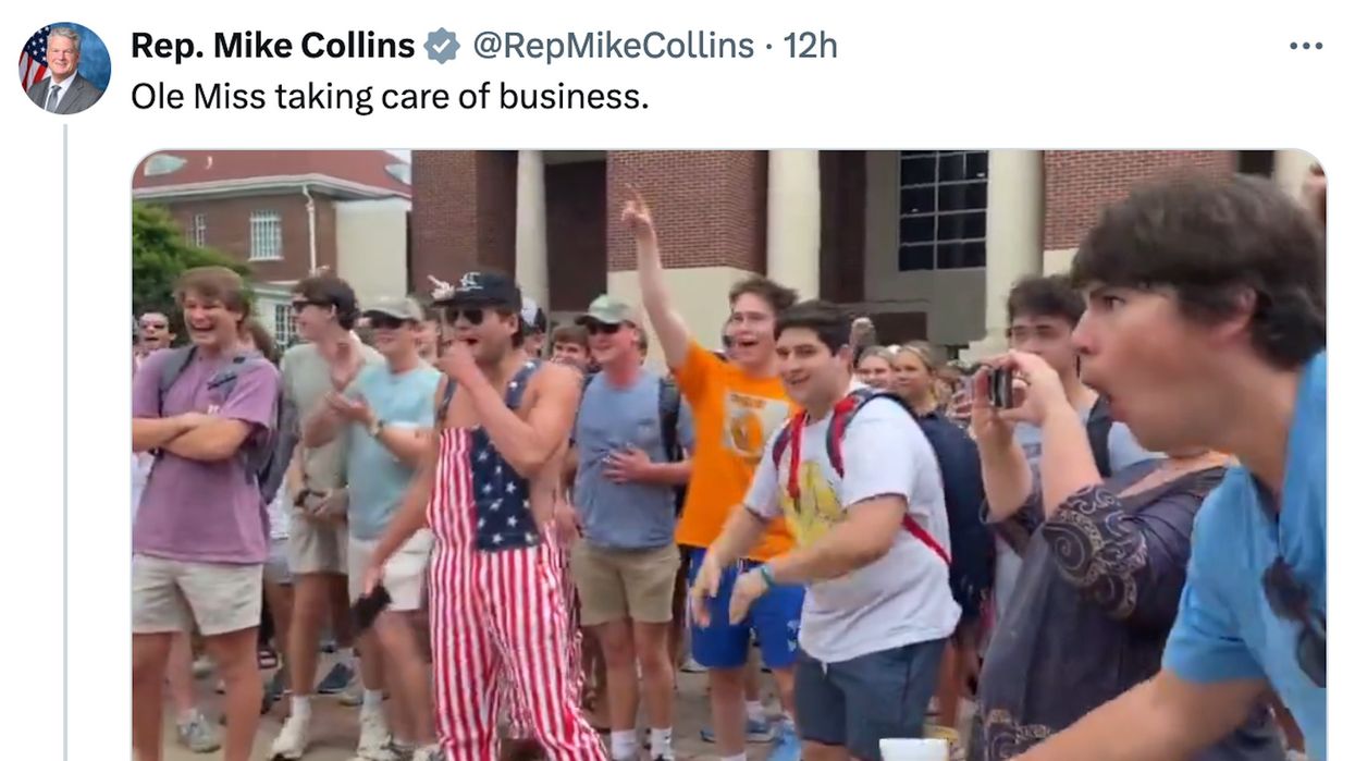 Ole Miss students make ape noises while a white male student jump ups and down in front of a Black student