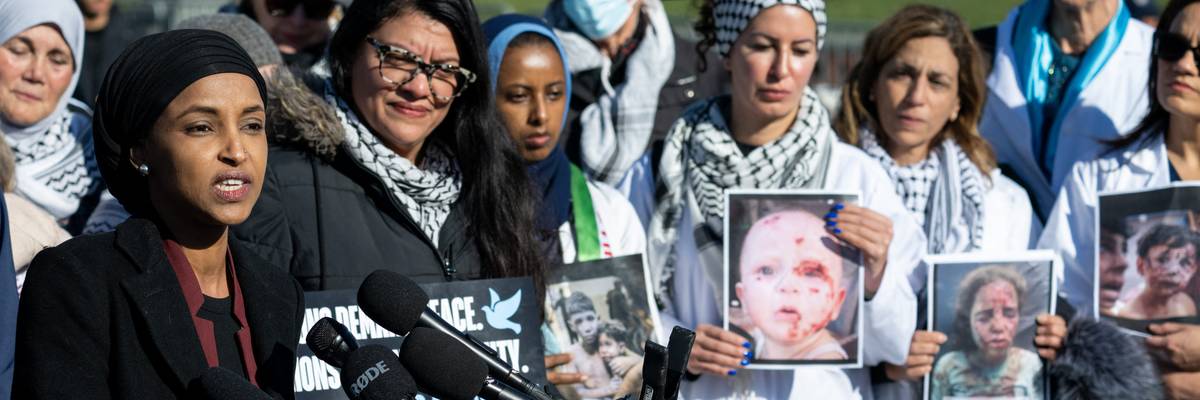 Omar and Tlaib hold up photos of children injured in Gaza.