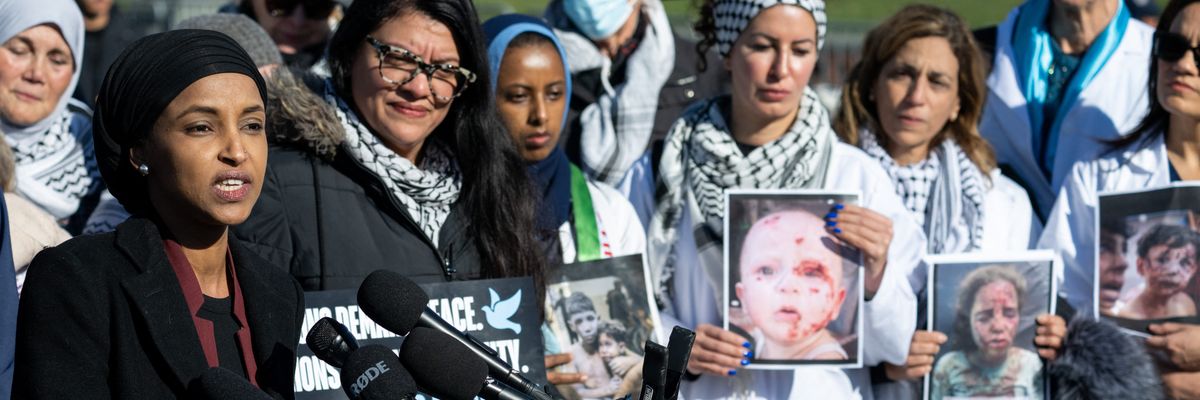 Omar and Tlaib hold up photos of children injured in Gaza.