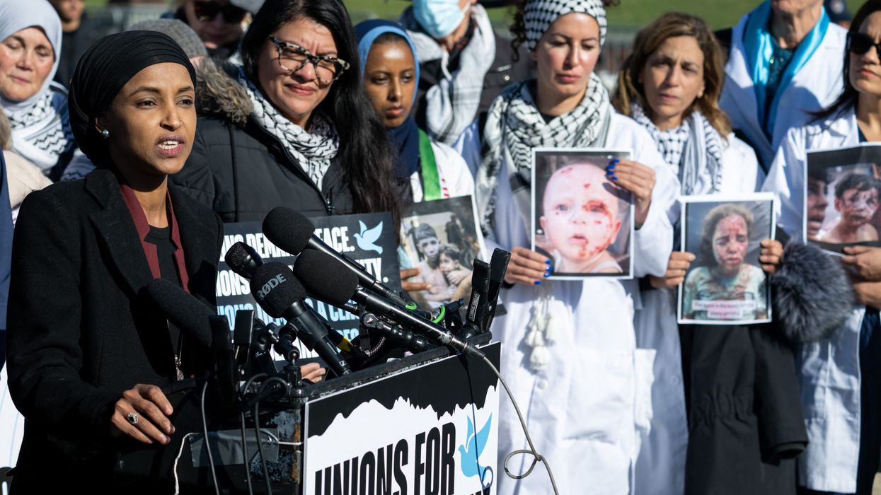 Omar and Tlaib hold up photos of children injured in Gaza.
