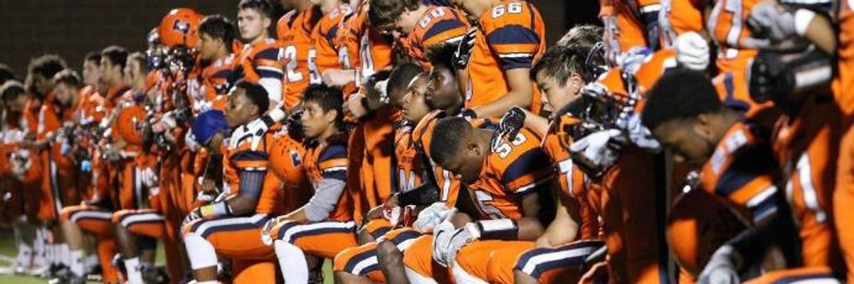 ome members of the Evanston football team take a knee during the national anthem before a game against New Trier in Evanston, Illinois on September 28, 2017