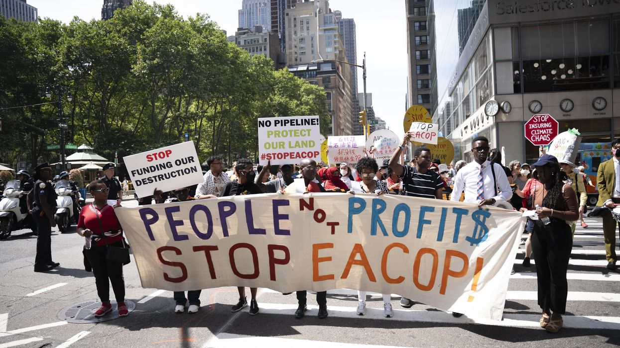 Opponents of EACOP carry a banner in NYC