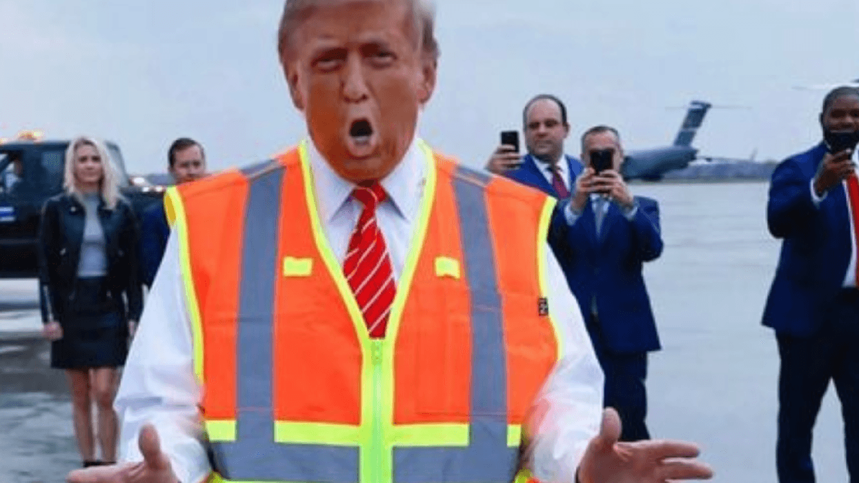 Orange blow-up garbagemen Donald Trump speaks at Green Bay airport