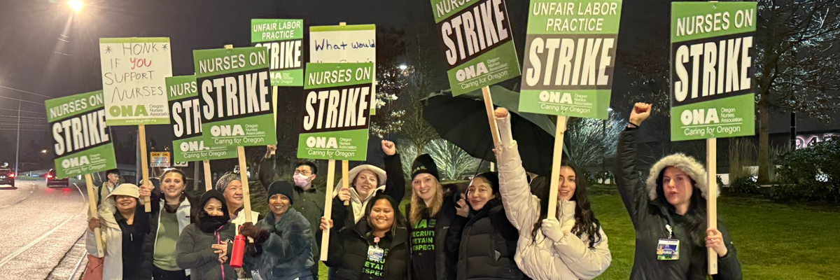 Oregon nurses on a picket line hold up signs announcing they're on strike