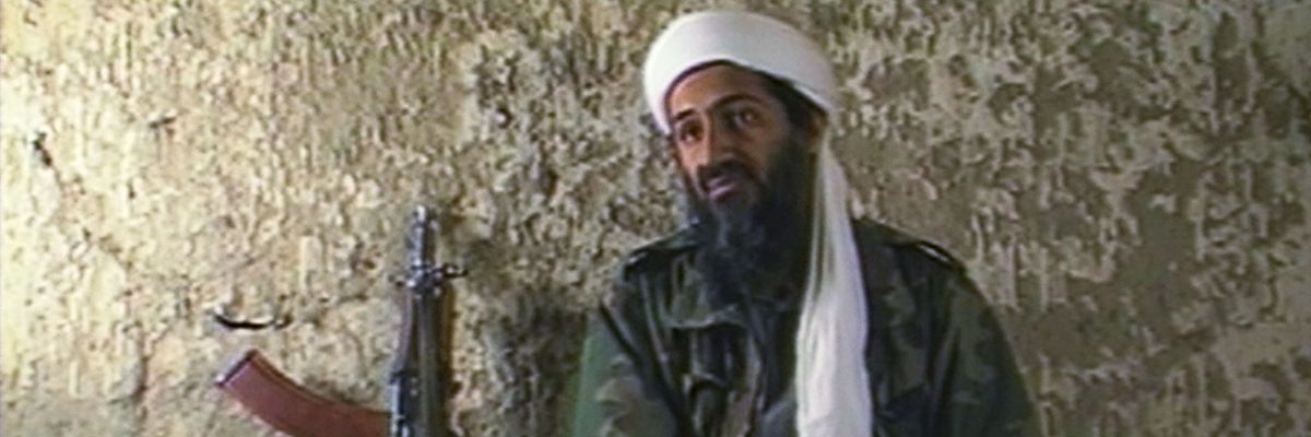 Osama bin Laden sits in a cave.