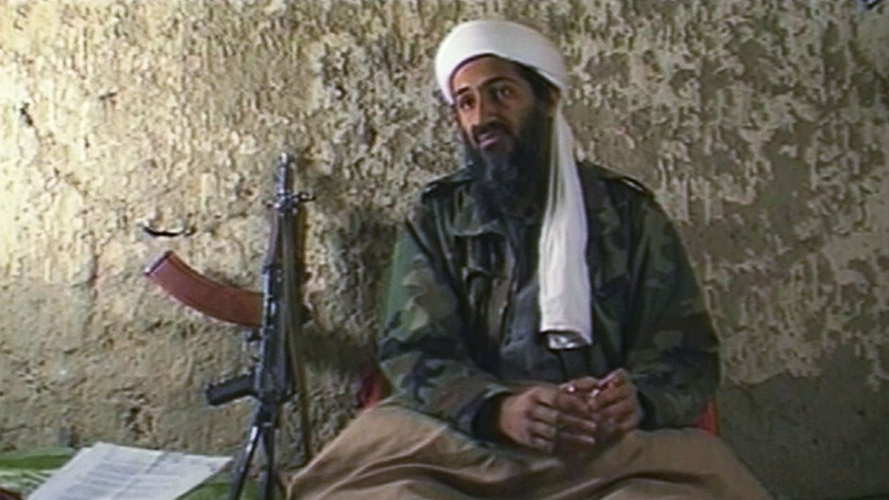 Osama bin Laden sits in a cave.