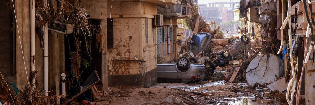 Overturned cars lay among other debris caused by flash floods in Derna