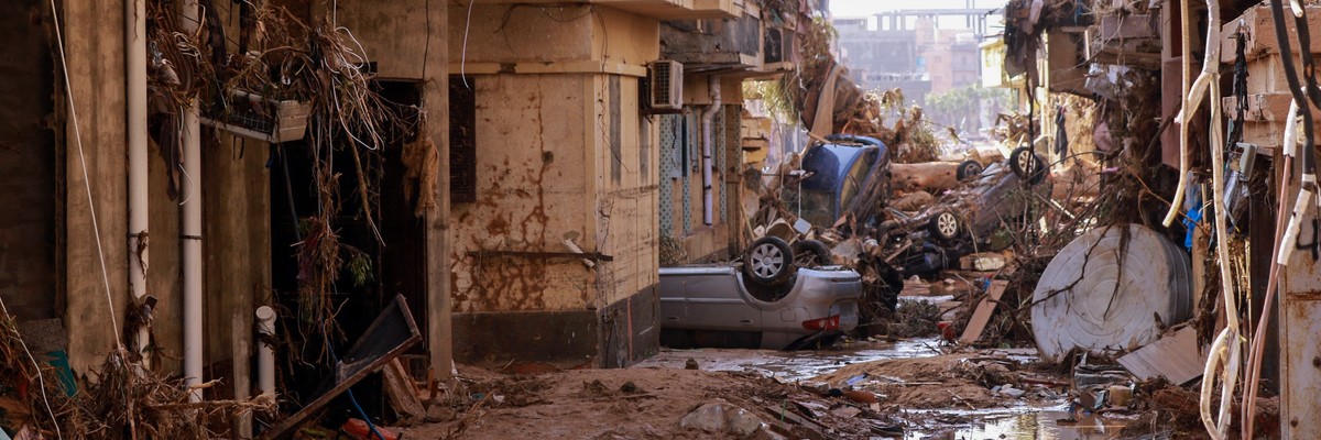 Overturned cars lay among other debris caused by flash floods in Derna