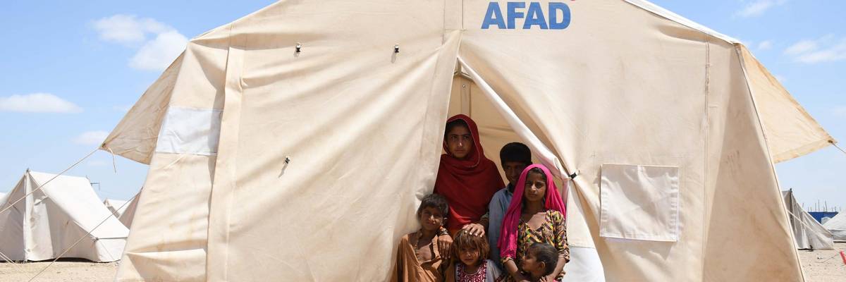 Pakistani flood victims are seen at an emergency tent