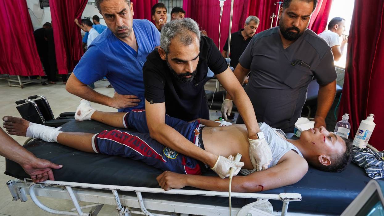 Palestinian boy receives treatment after the Israeli forces attacked the Nuseirat refugee camp