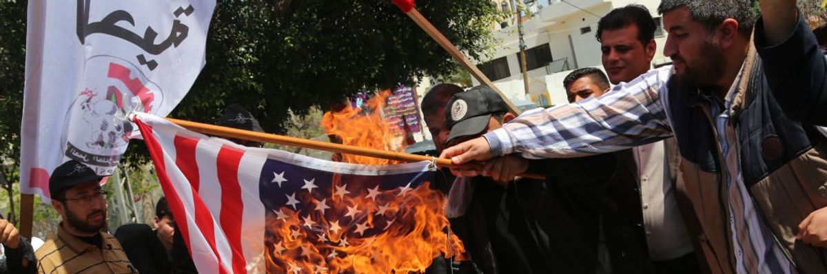 Palestinian burn American flag to Protest Against Operations In Syria by the US