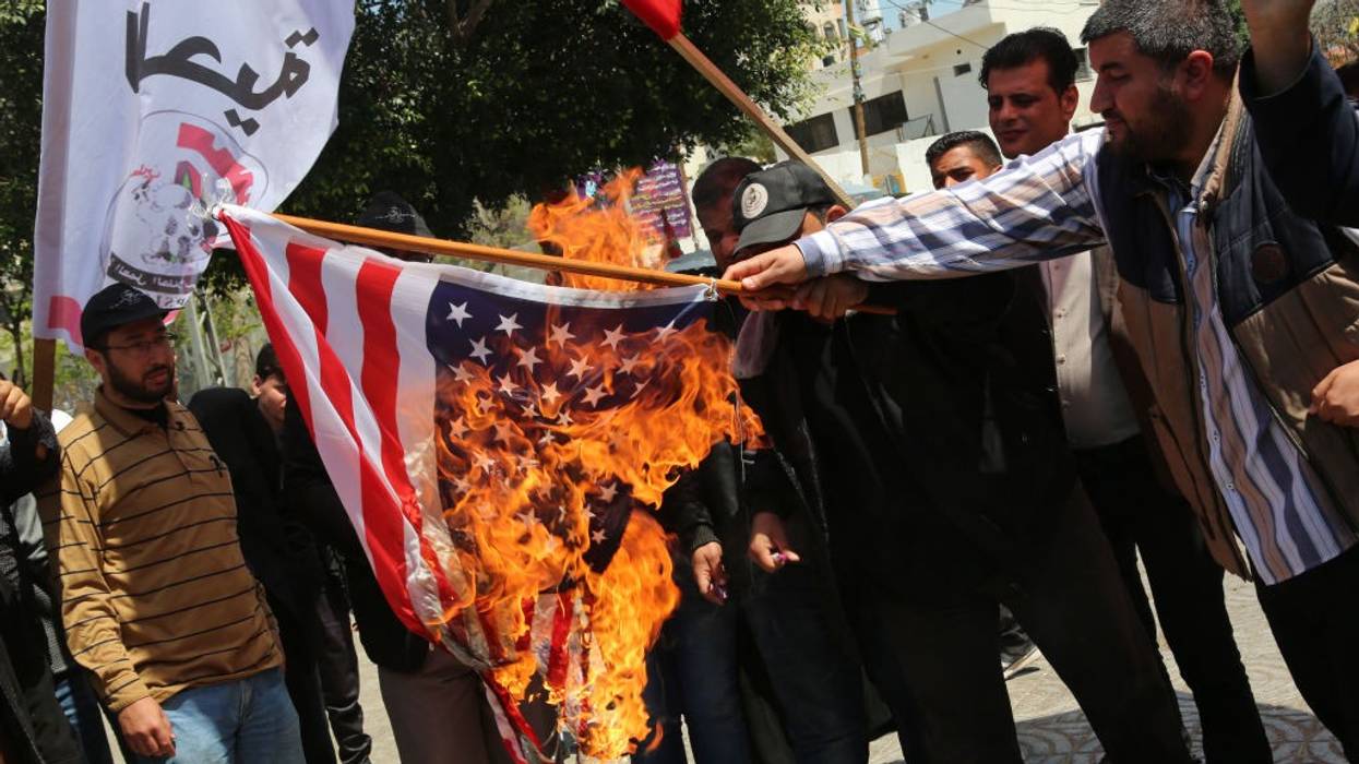 Palestinian burn American flag to Protest Against Operations In Syria by the US