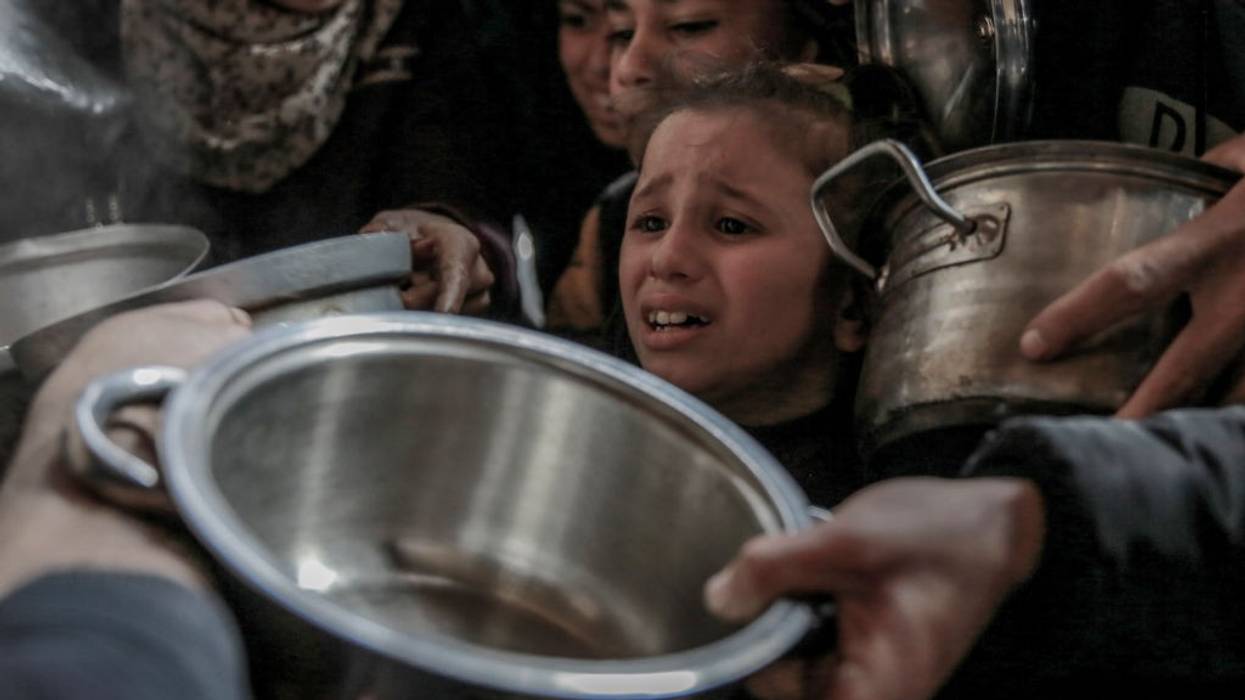 Palestinian child cries waiting for food in Rafah