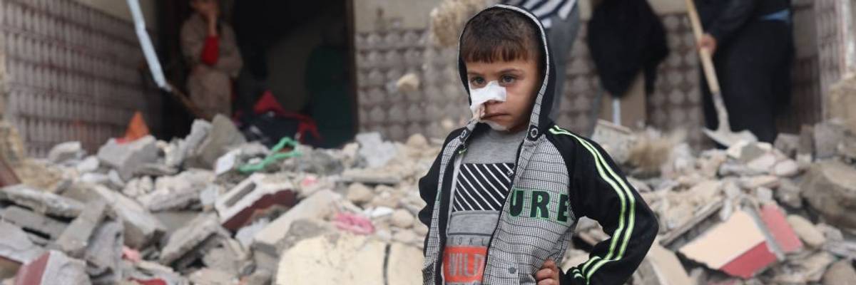 Palestinian child in rubble of Gaza