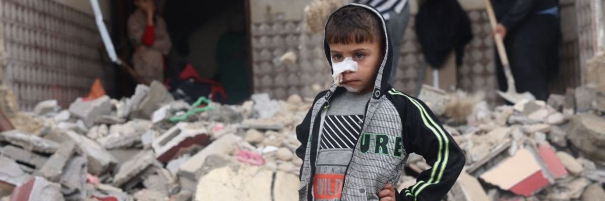 Palestinian child in rubble of Gaza