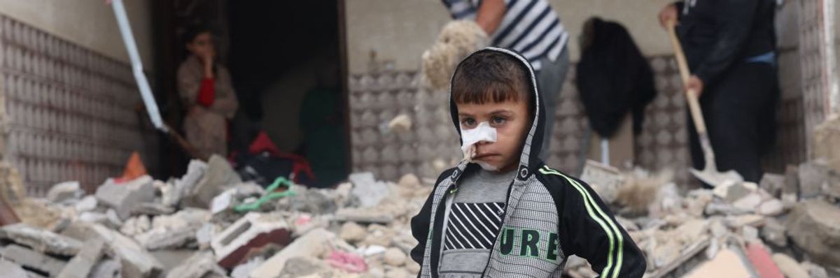 Palestinian child in rubble of Gaza
