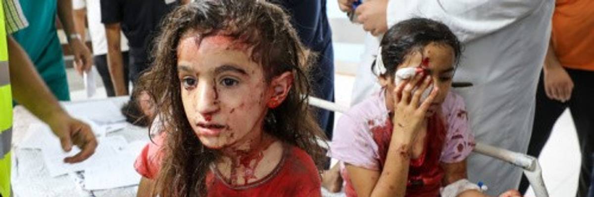 Palestinian children bloodied by Israeli air strikes in Gaza's Al-Shifa Hospital in Gaza City