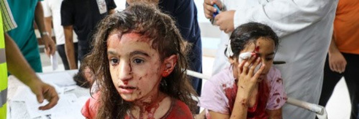 Palestinian children bloodied by Israeli air strikes in Gaza's Al-Shifa Hospital in Gaza City