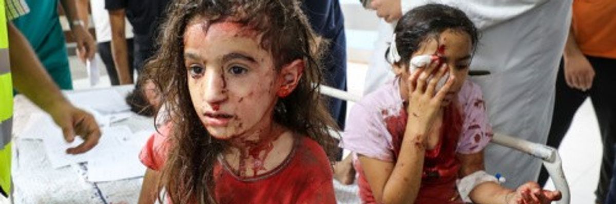 Palestinian children bloodied by Israeli air strikes in Gaza's Al-Shifa Hospital in Gaza City