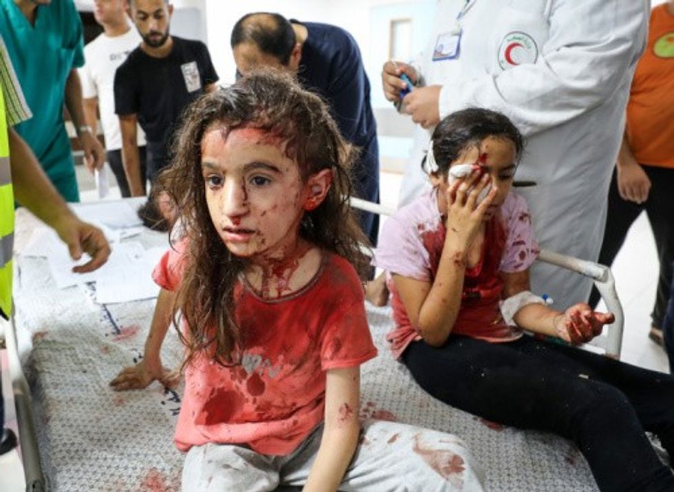 Palestinian children bloodied by Israeli air strikes in Gaza's Al-Shifa Hospital in Gaza City