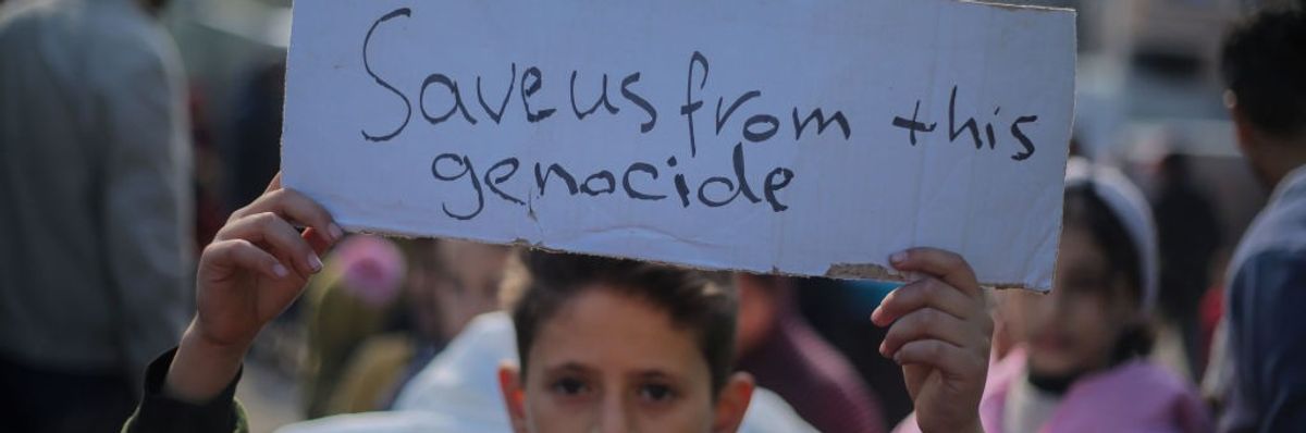 Palestinian children hold placards