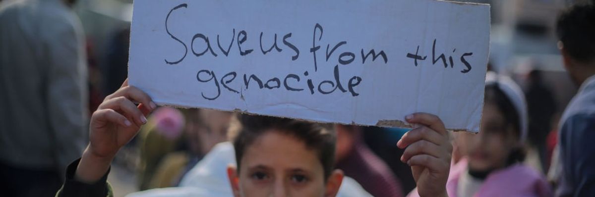 Palestinian children hold placards 