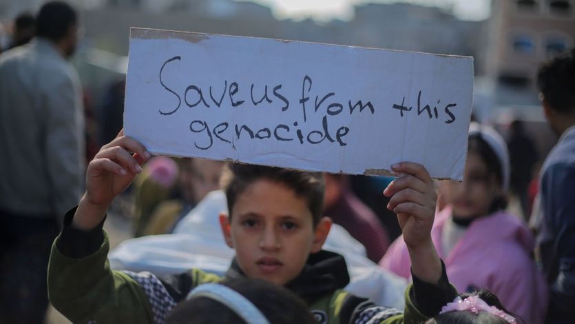Palestinian children hold placards