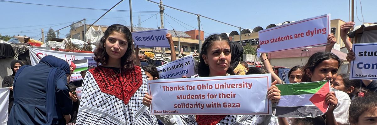 Palestinian children in the Gaza Strip hold a press conference and event in the courtyard of a school turned into a shelter in the city of Rafah