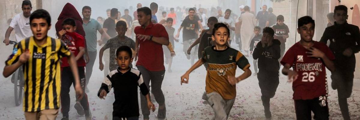Palestinian children run to flee Israel bombs in Gaza
