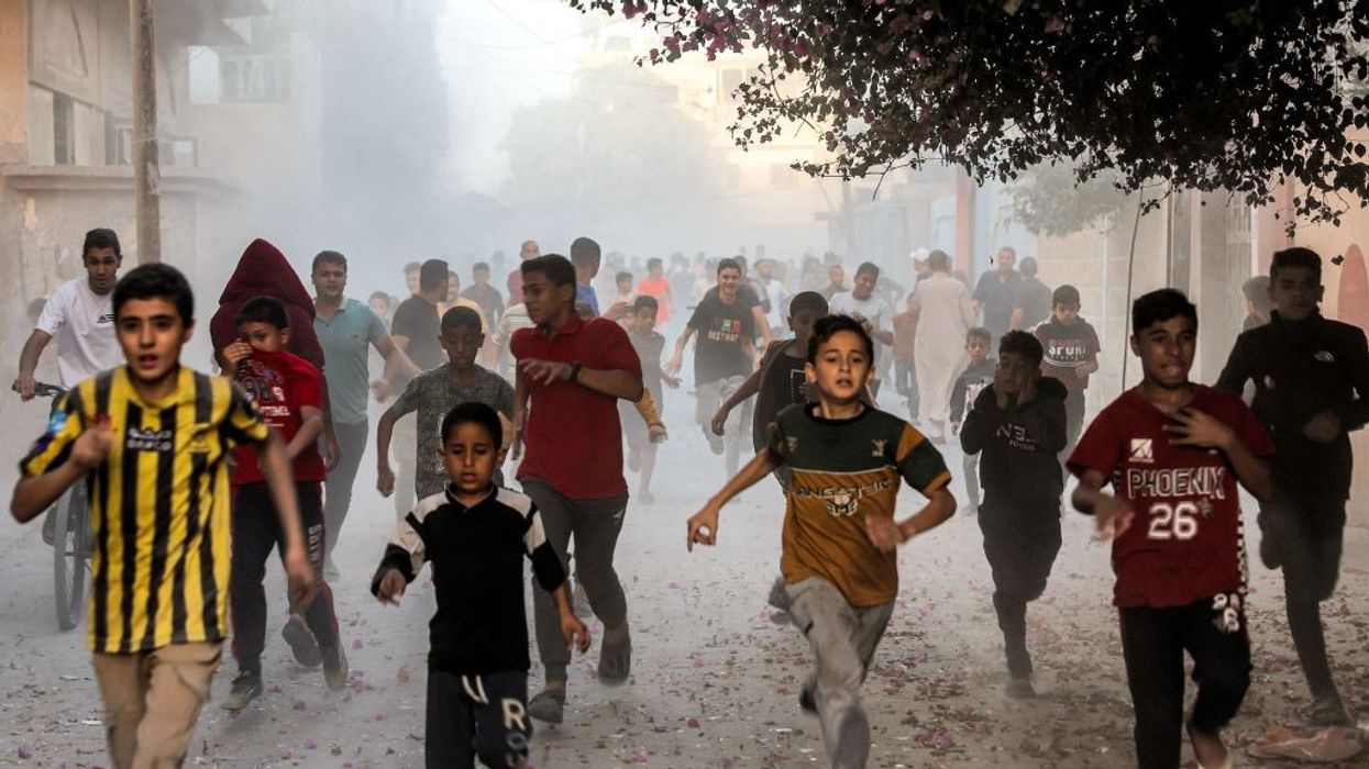 Palestinian children run to flee Israel bombs in Gaza